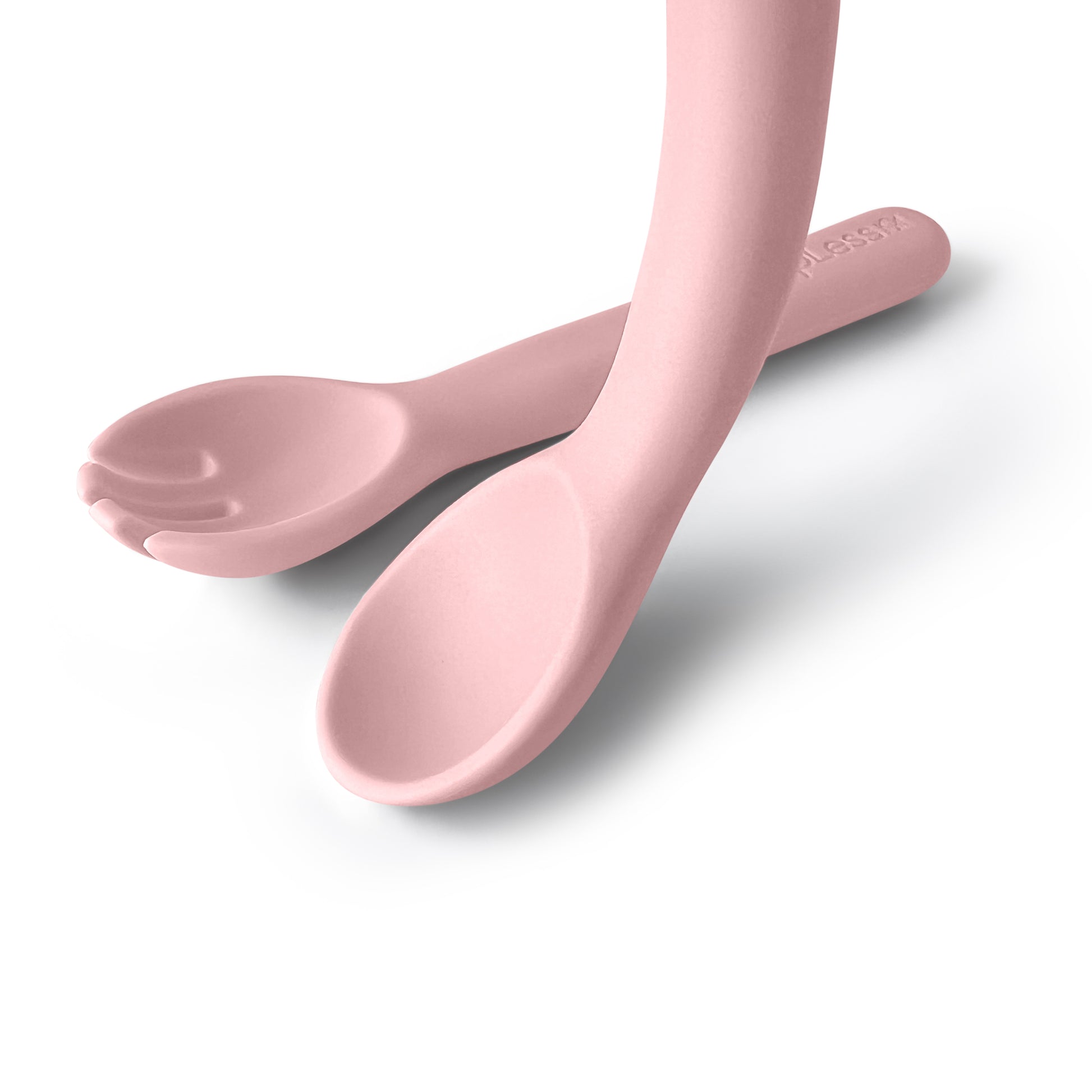 Two pink spoons on a white background